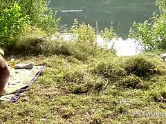 O femeie matură înghite sperma și se pișă în public la un lac de înot