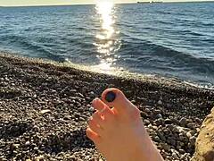 Mistress Lara indulges in foot worship and toe play on the beach