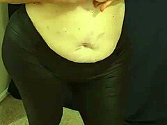 Fat MILF with big natural tits dances and masturbates in pink micro bikini before using lotion