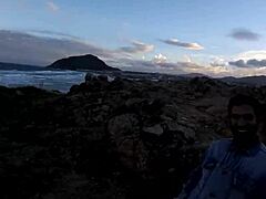 Arousing video of a young girl giving a blowjob on the rocks by the sea